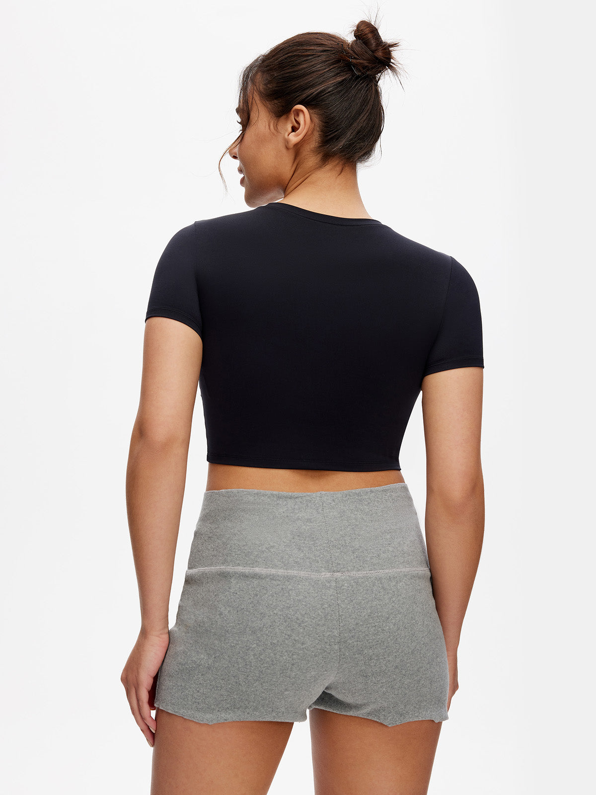 Back view of black cropped t shirt – fitted workout top with clean finish and soft stretch fabric