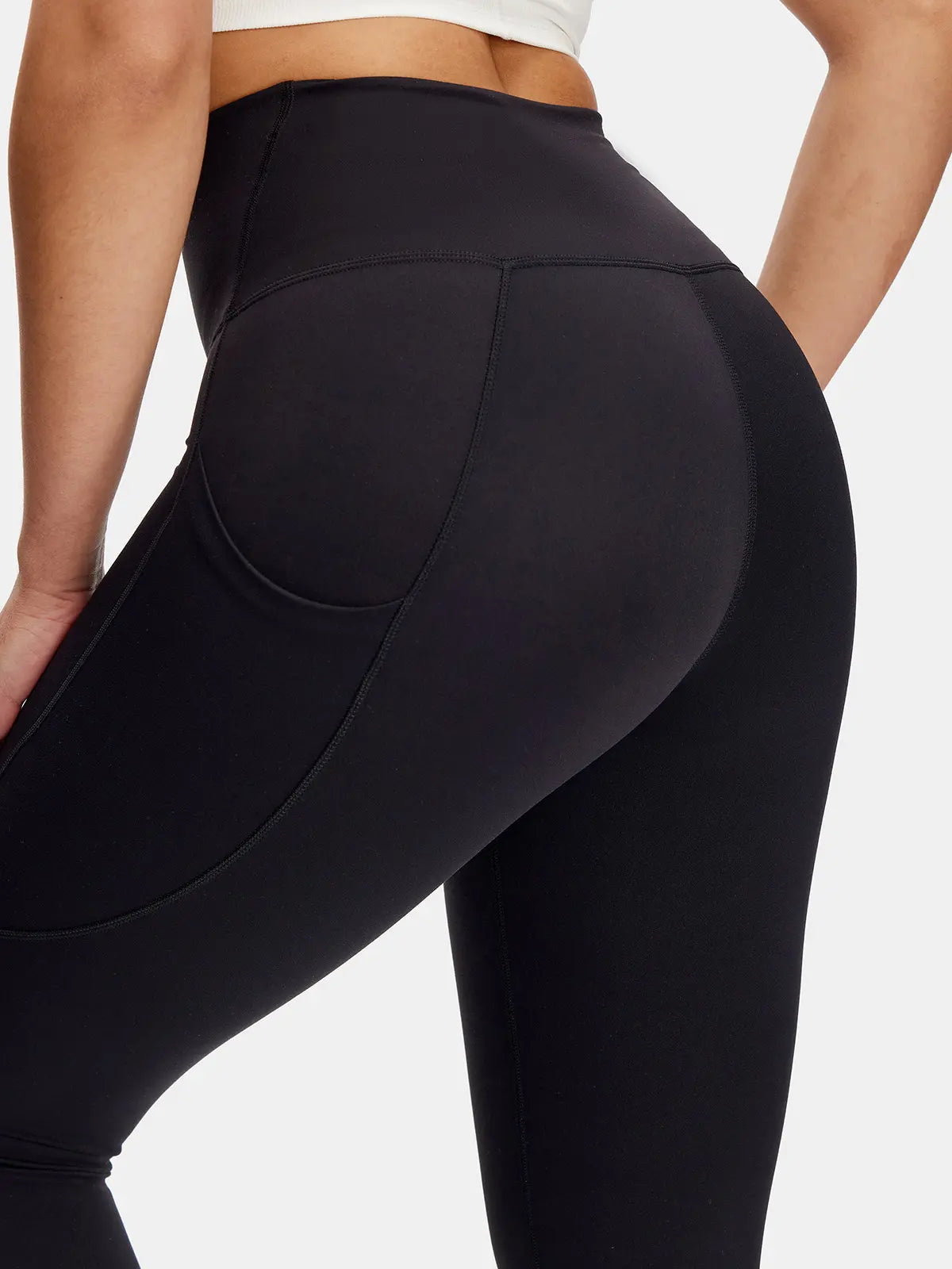 Black leggings worn by a person on a plain background
