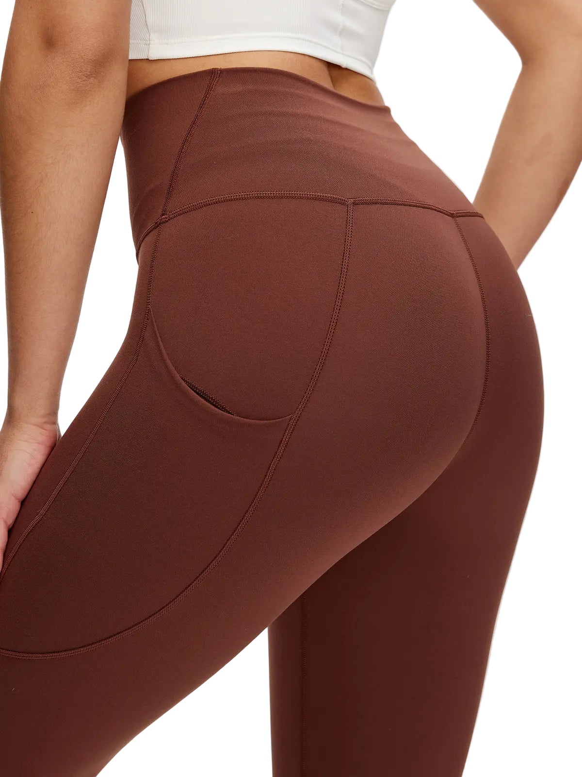 Brown leggings worn by a person on a white background