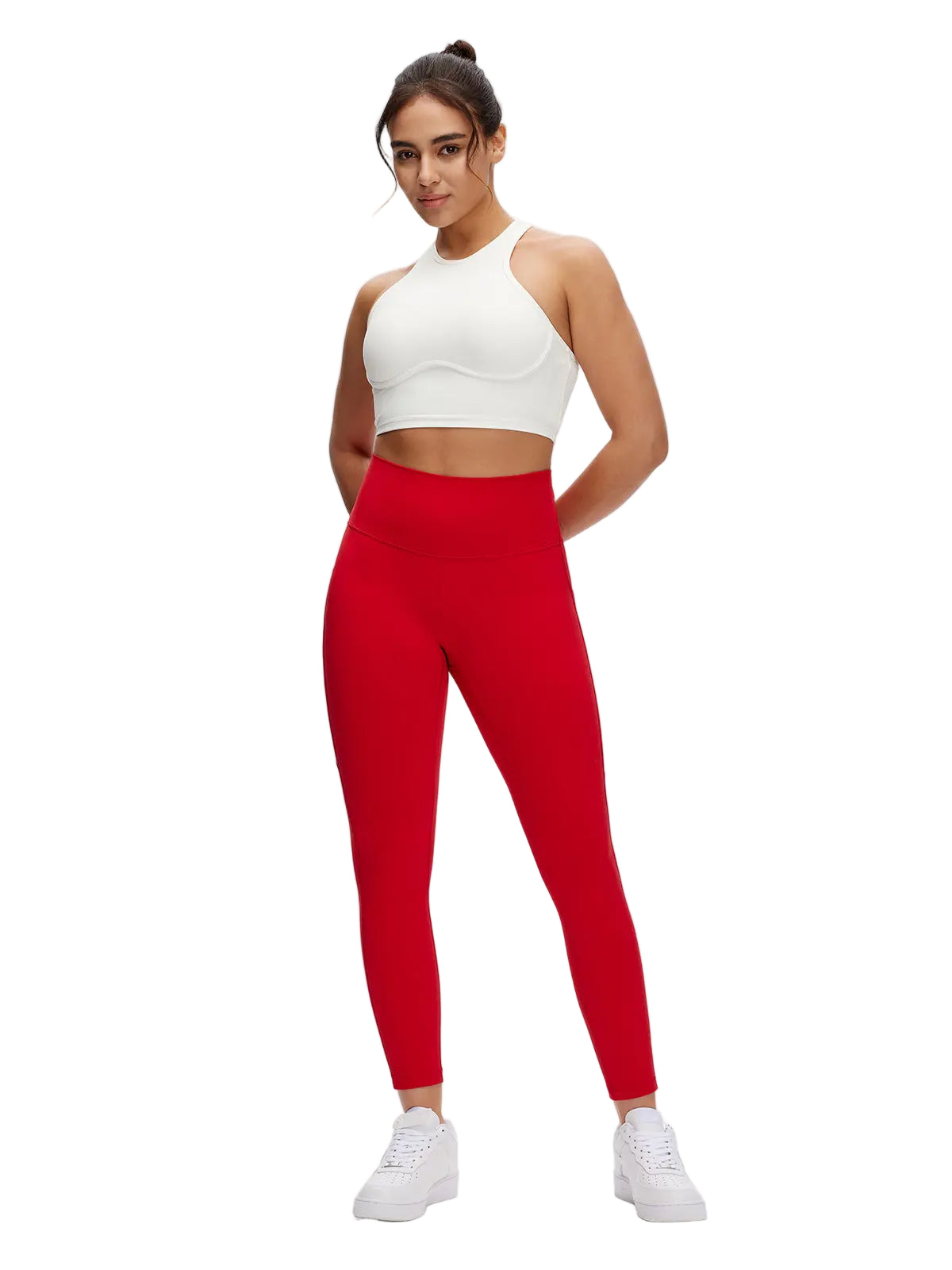 Woman wearing a white crop top and red leggings on a white background