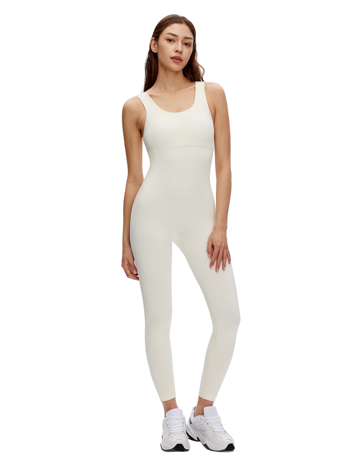 Woman wearing white ribbed bodycon jumpsuit with scoop neck and sleeveless design, perfect for workouts or casual wear.