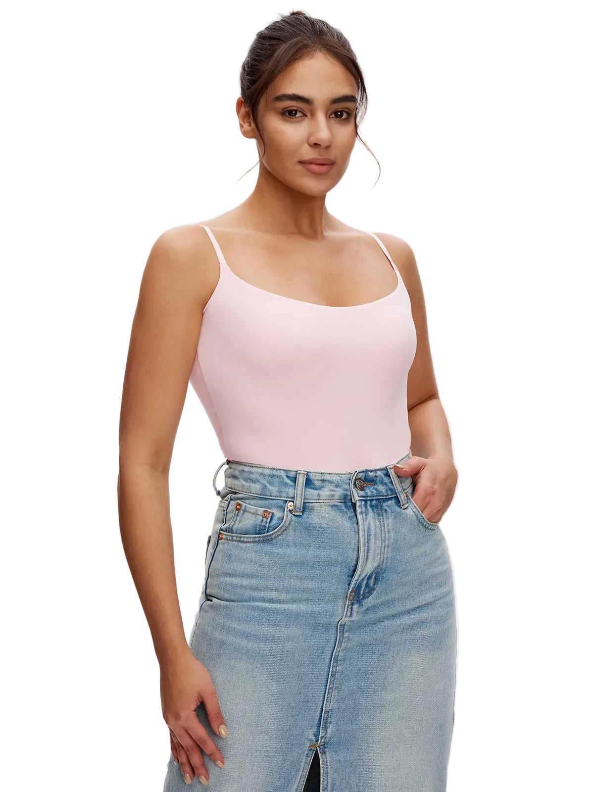 Woman wearing a pink tank top and blue jeans on a white background