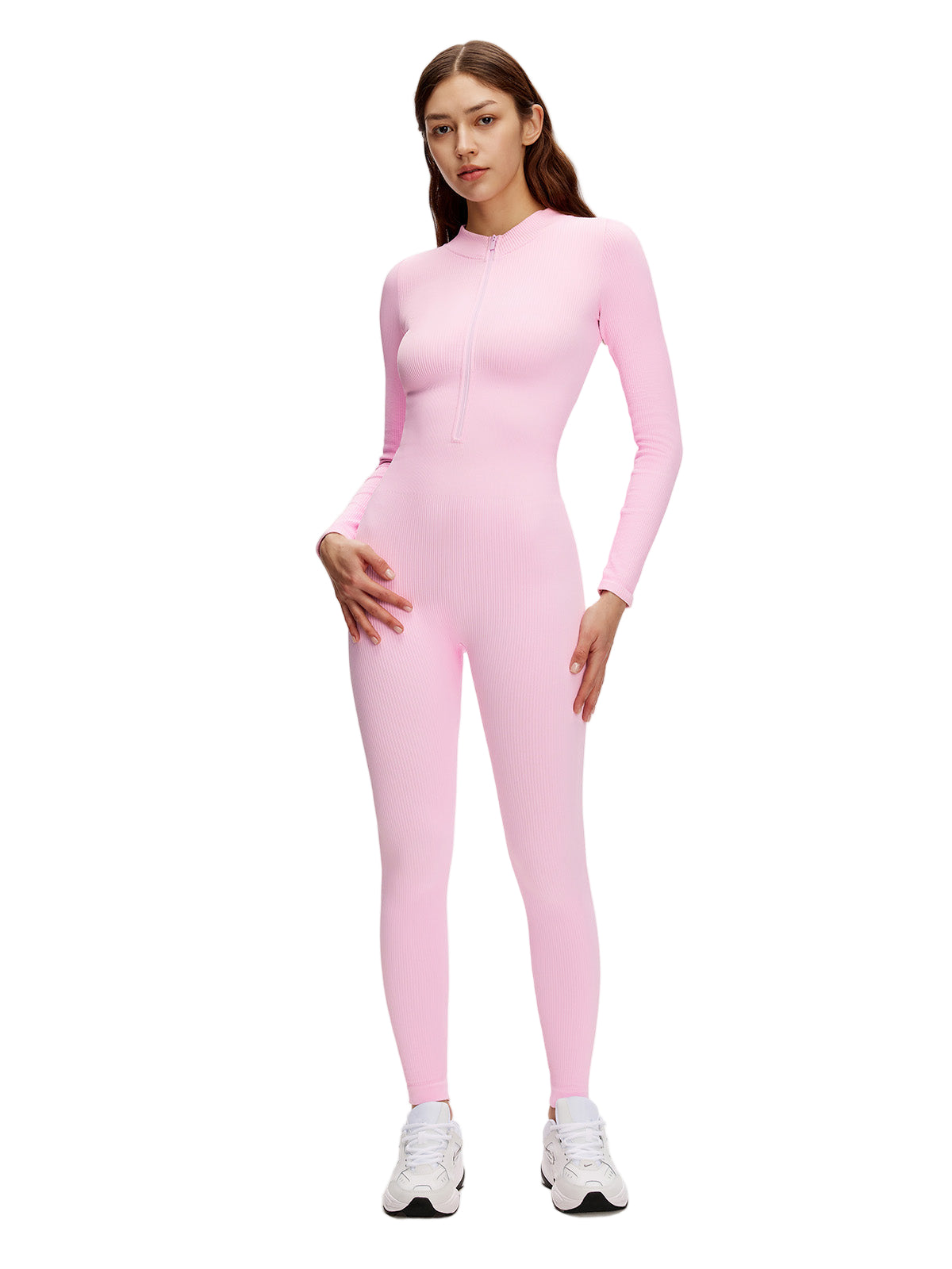 Model in soft pink zip-up ribbed jumpsuit; long sleeves, fitted body, and elegant scoop neckline.