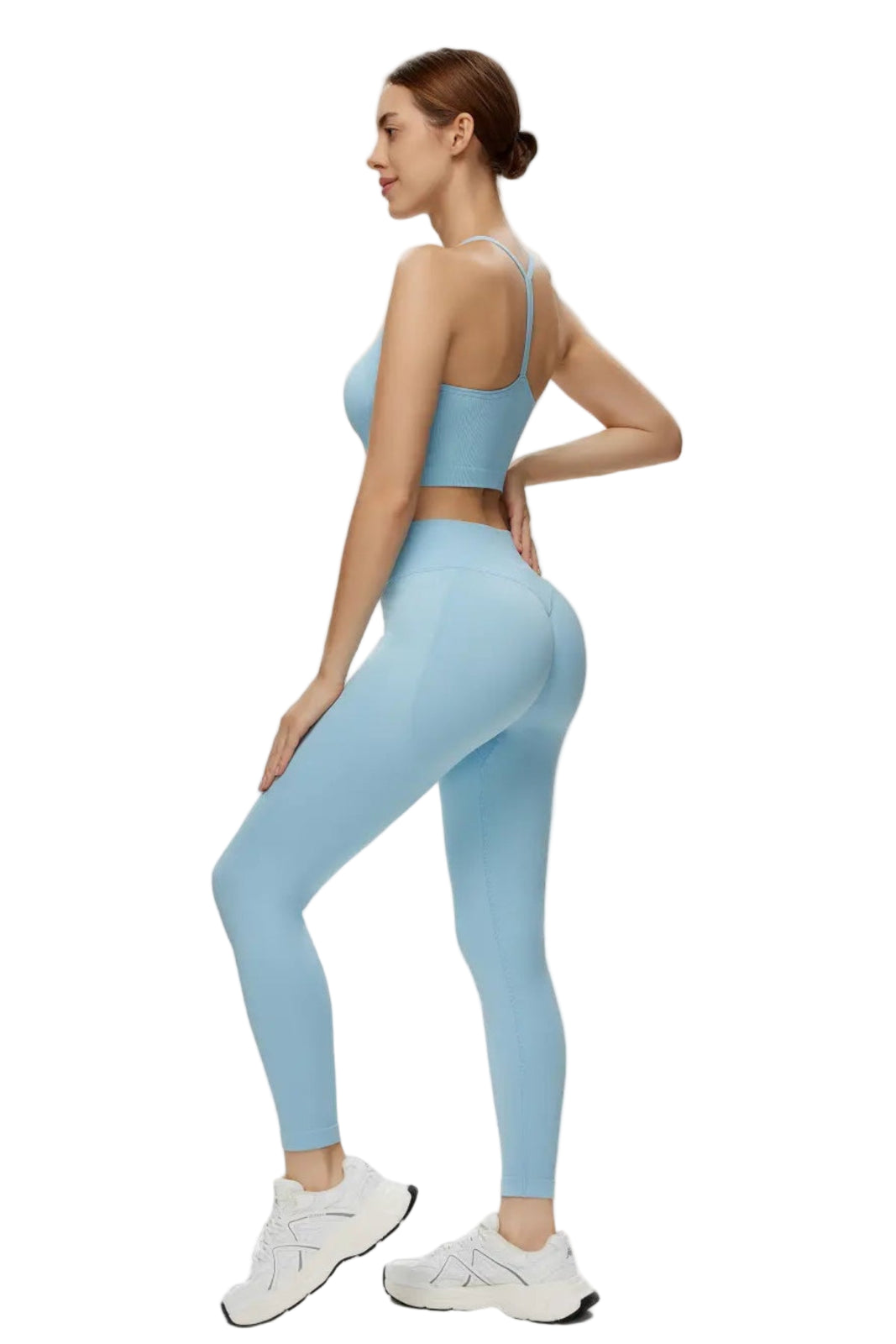 Woman wearing a light blue athletic outfit on a white background