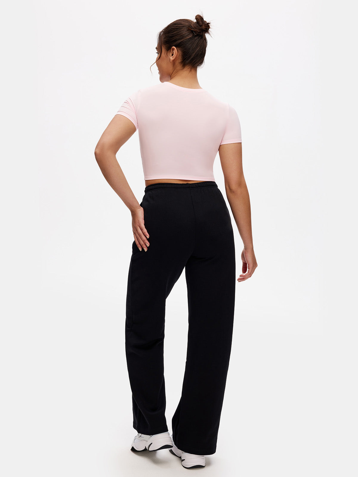 Back view of black cropped t shirt – fitted workout top with clean finish and soft stretch fabric