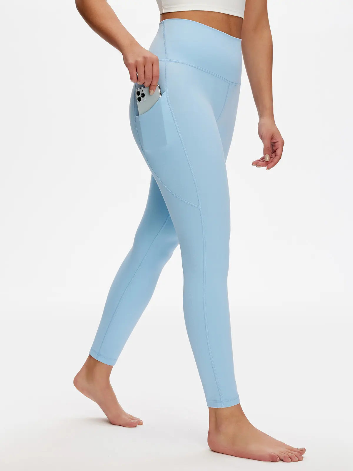 Light blue leggings worn by a person on a white background