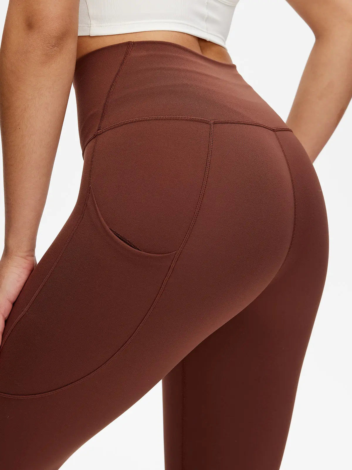 Brown leggings worn by a person on a white background
