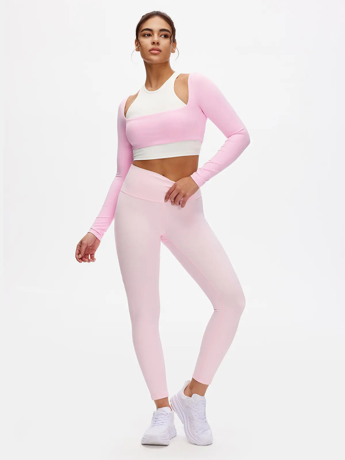 Person wearing a pink and white athletic outfit on a white background