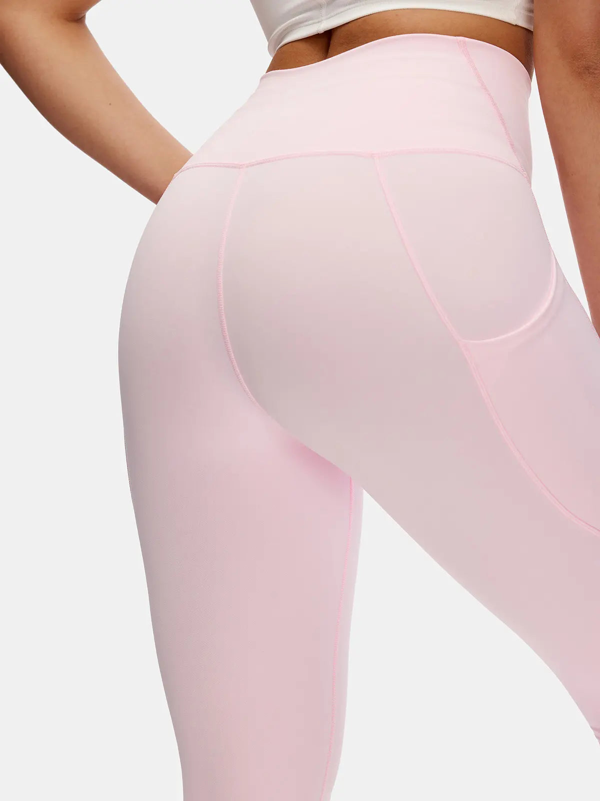 Close-up of pink leggings on a plain background
