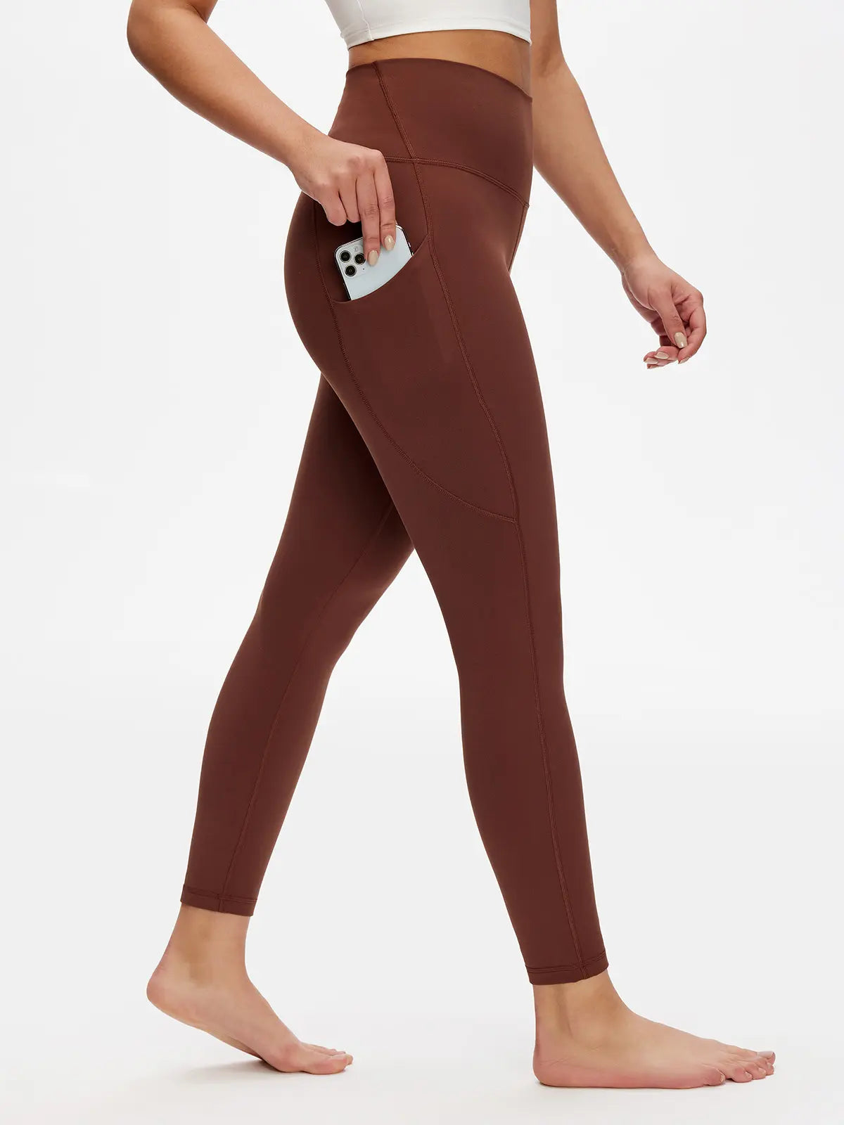 Brown leggings worn by a person on a white background