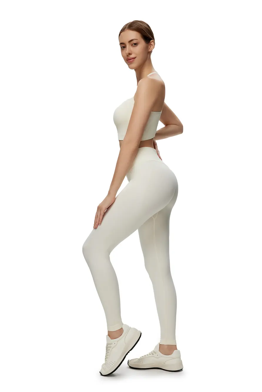 Woman wearing a white athletic outfit on a white background