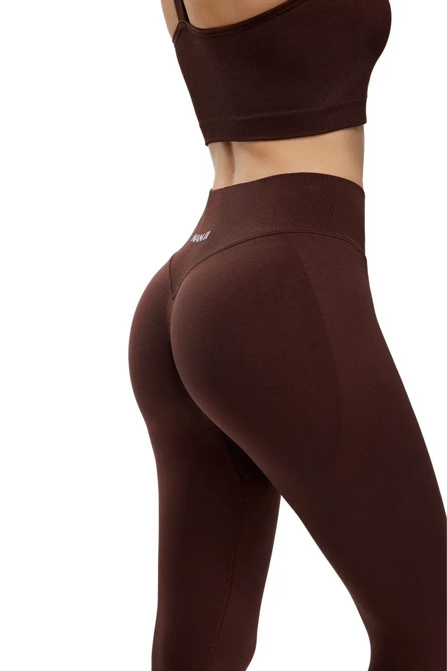 Brown athletic leggings and crop top on a white background